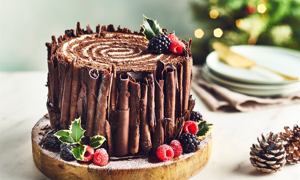 Chocolate Christmas celebration cake with holiday decorations Stock Photo -  Alamy